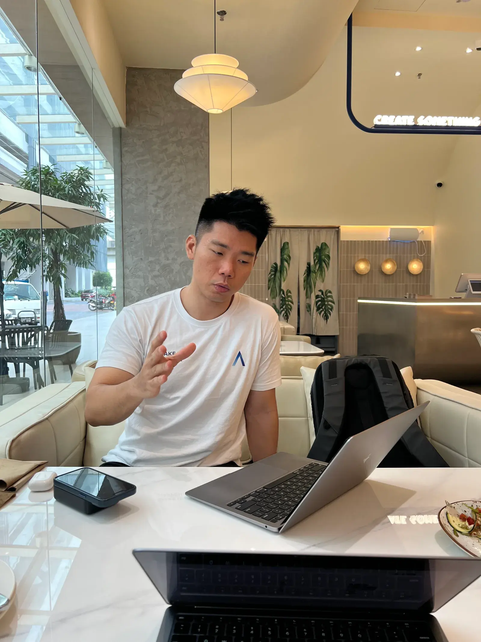 Adrian Ching speaking while working at a laptop