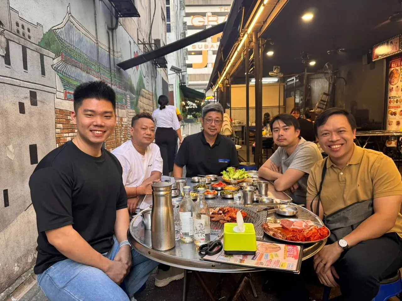 Adrian Ching at dinner with his EO Trailblazers coach, an EO member and two Accountability Group members
