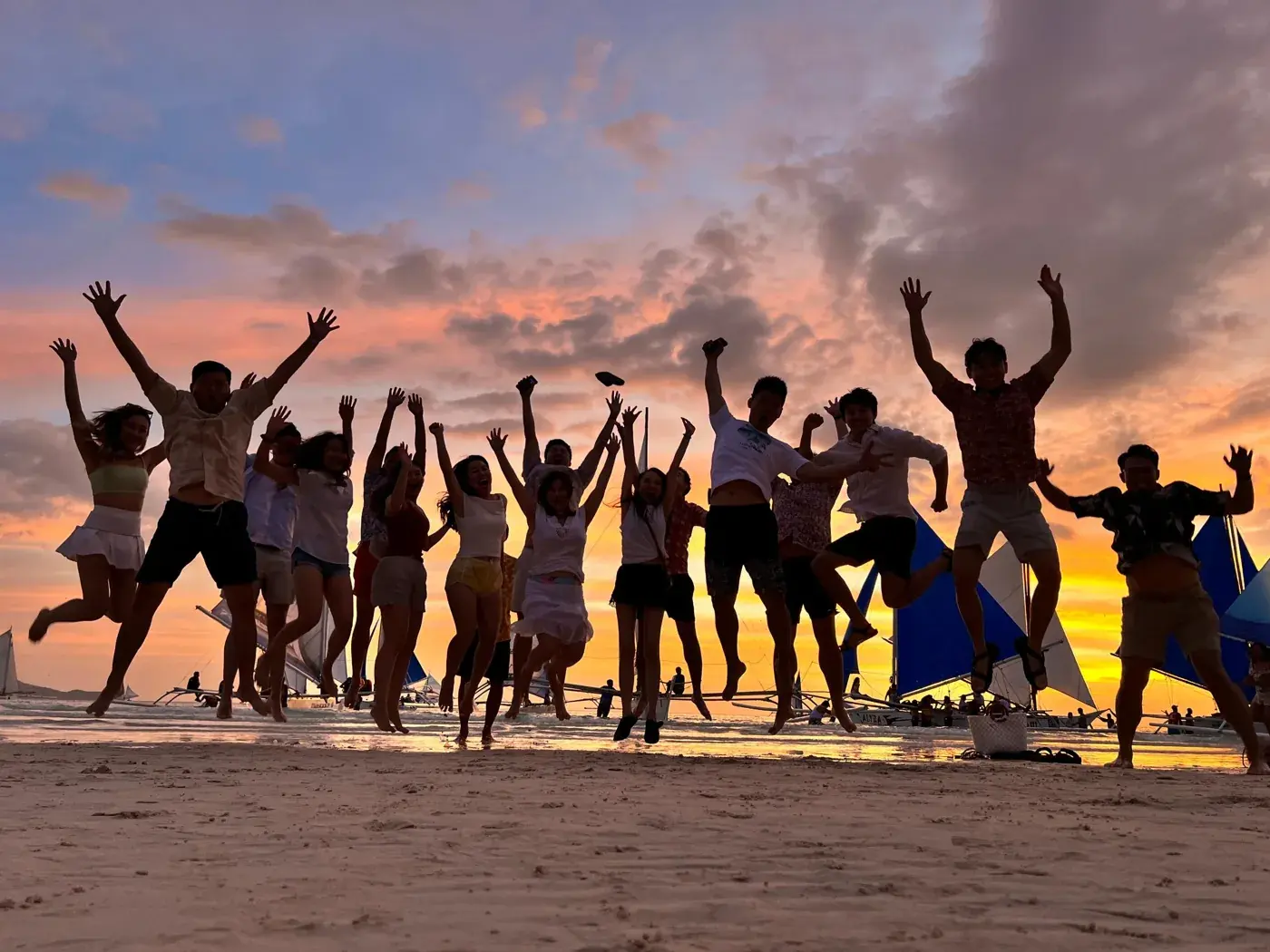 Adrian Ching and the Trailblazers group jumping on the beach at their Boracay retreat